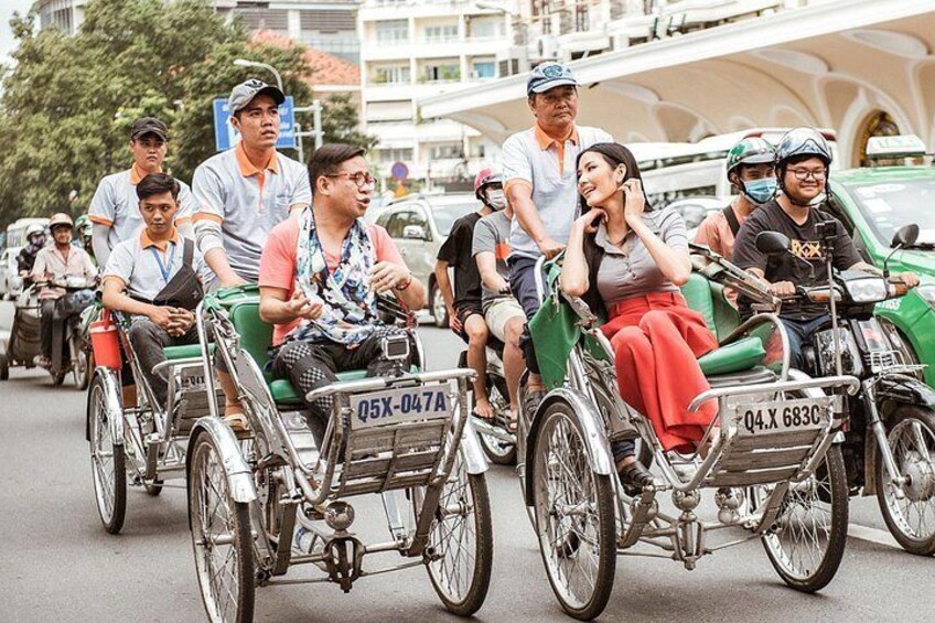 A group of people riding decorated bicycles on a street. 1