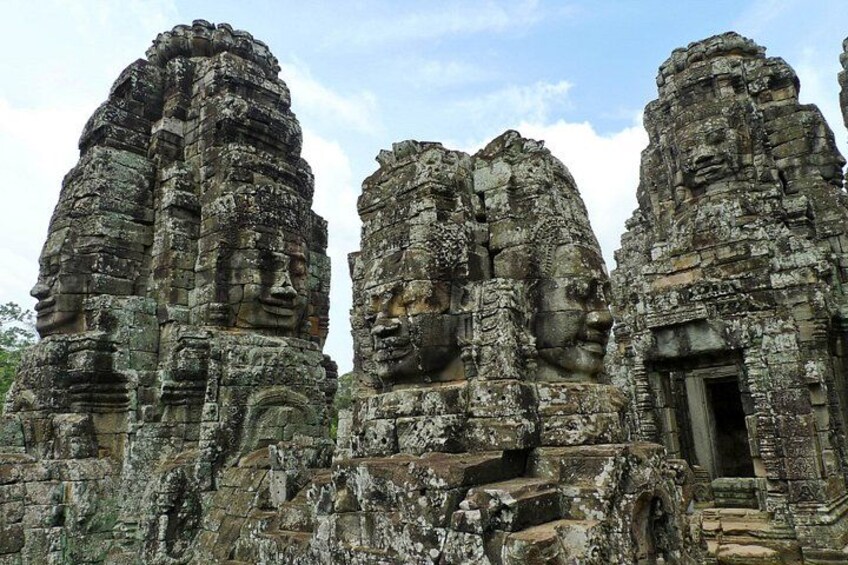 Ancient stone structures with intricate carvings and a doorway. 4