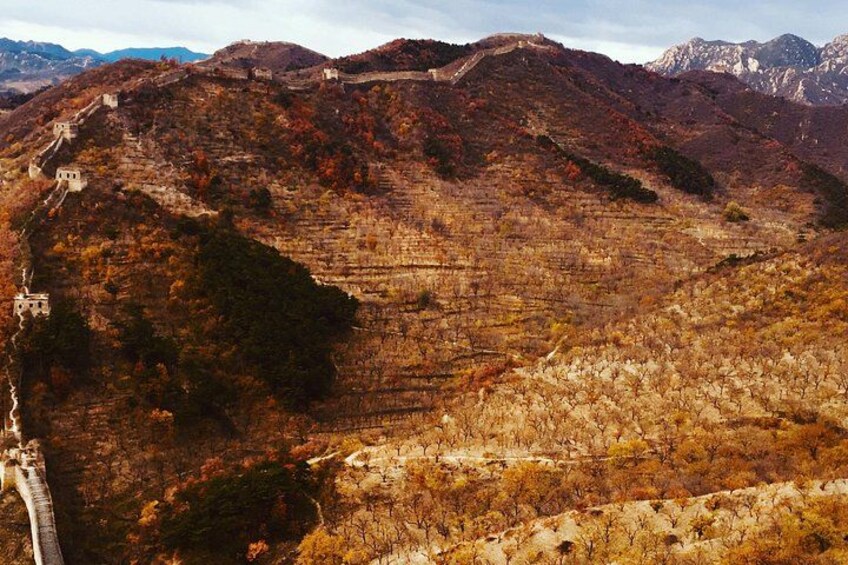 A mountainous landscape with terraced fields and a winding road. 5