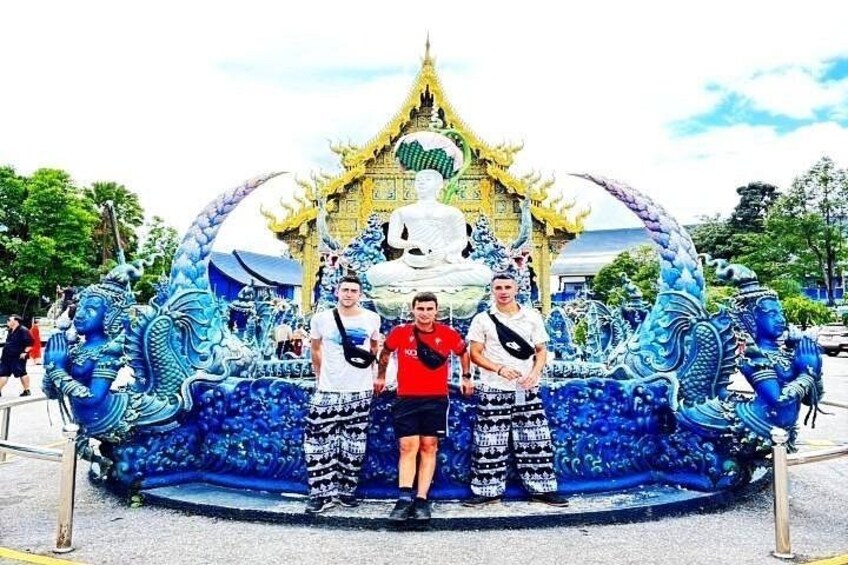 A dragon sculpture with three people standing in front. 2