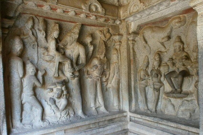 A detailed stone carving of multiple figures in a temple. 3
