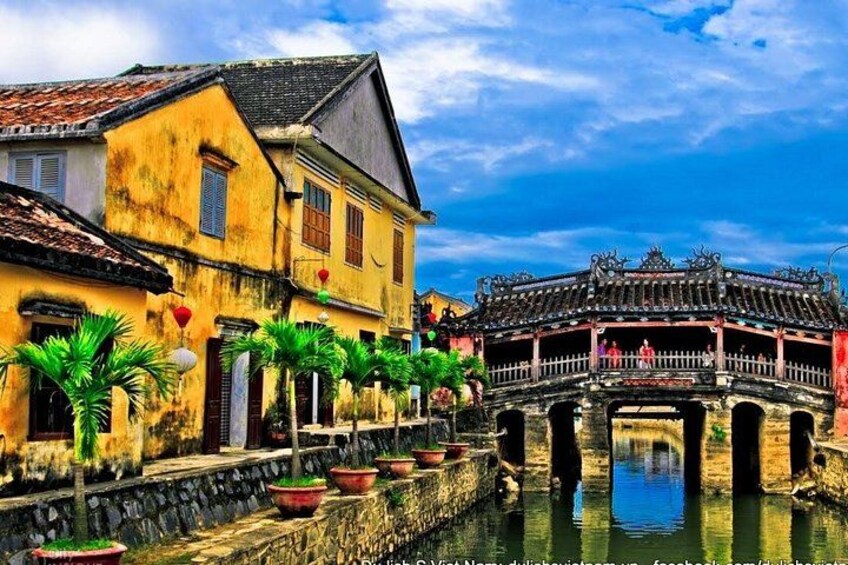 A traditional bridge over a canal, with old buildings on either side. 2