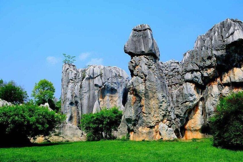 A rocky landscape with prominent rock formations and green vegetation. 5