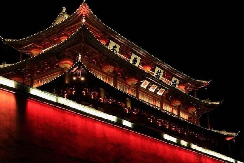 A traditional Chinese building with ornate architecture and illuminated details. 4