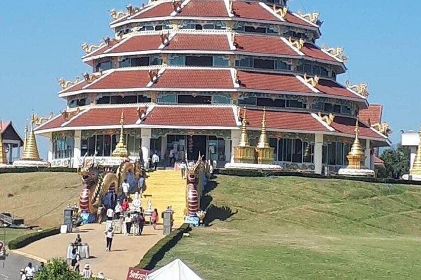 A multi-tiered temple with a red roof and golden decorations. 4