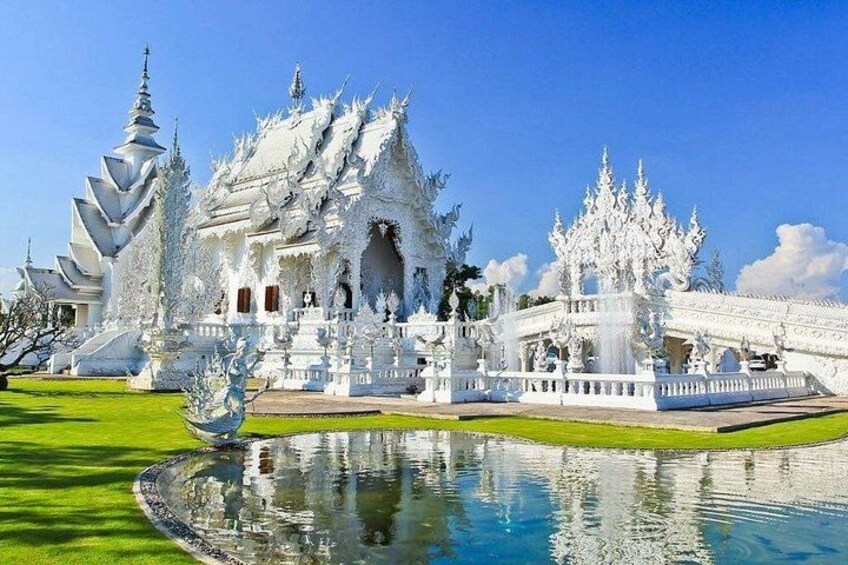 A white temple with a lotus pond and a bridge. 1