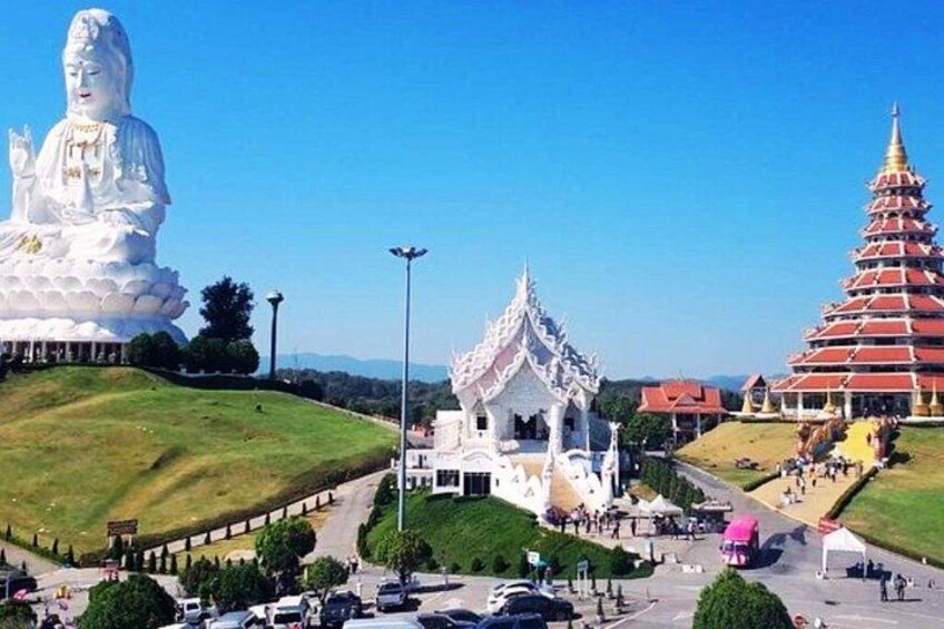 A large white Buddha statue, a traditional Thai temple, and a multi-tiered pagoda. 5