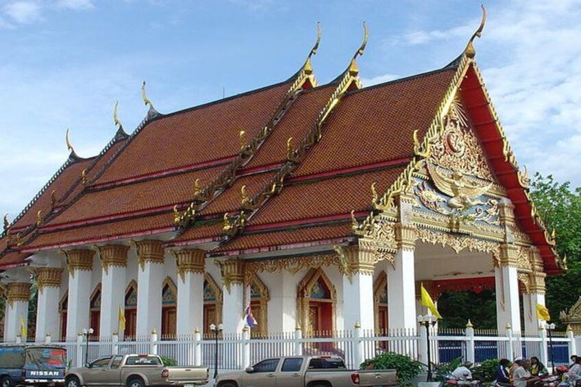 A traditional Thai temple with ornate golden decorations and a red roof. 4