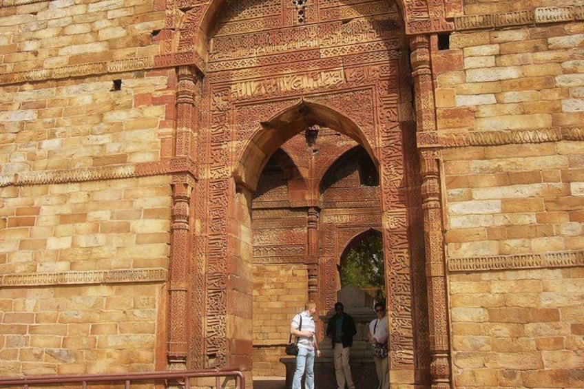 A large, intricately carved stone archway with detailed patterns and inscriptions. 3