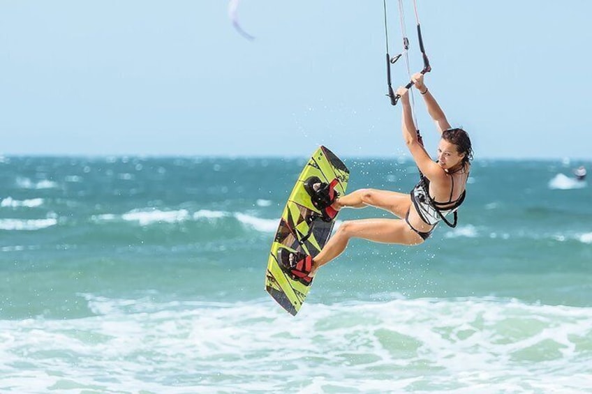 A person kiteboarding over the ocean. 1