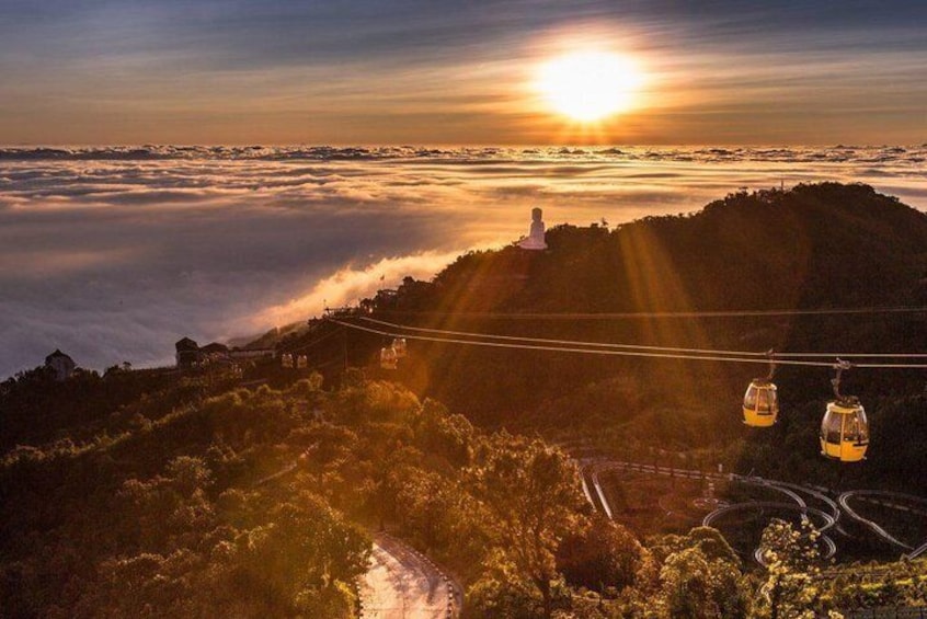 A sunrise over a coastal landscape with a cable car system and a lighthouse. 5
