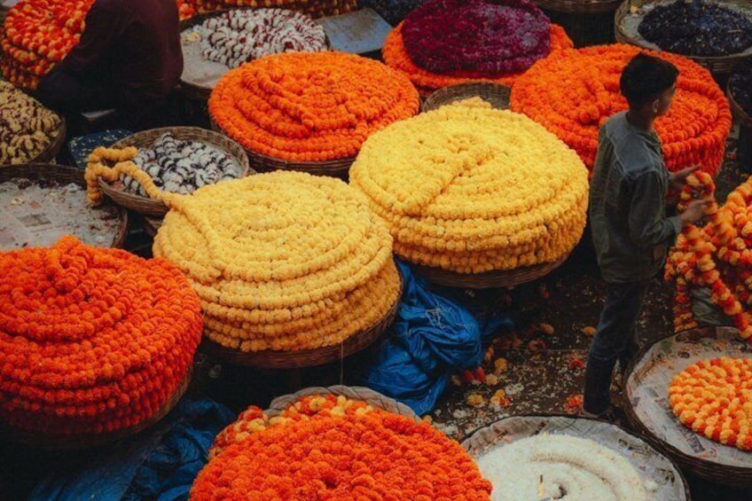 A market with large, colorful flower arrangements in baskets. 4
