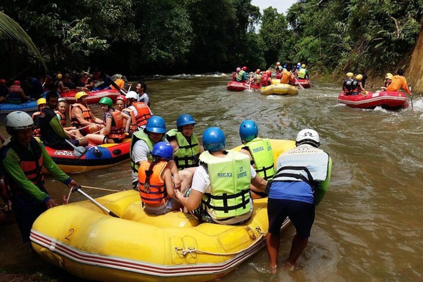 People in inflatable rafts on a river surrounded by dense greenery. 5