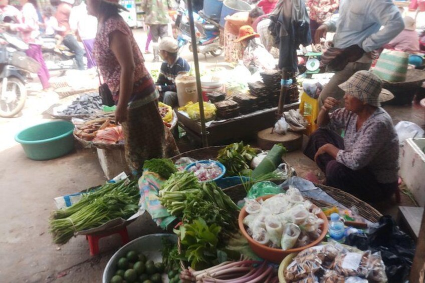 A market stall with various vegetables and seafood. 2