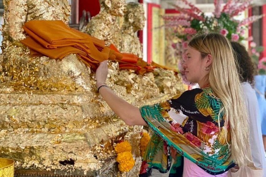 A simple, cultural activity at Chalong Temple — learning how locals decorate gold foils on statue as part of everyday temple visits. 5