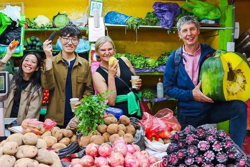 A market stall with various vegetables and fruits, including potatoes, onions, and a large pumpkin. 2