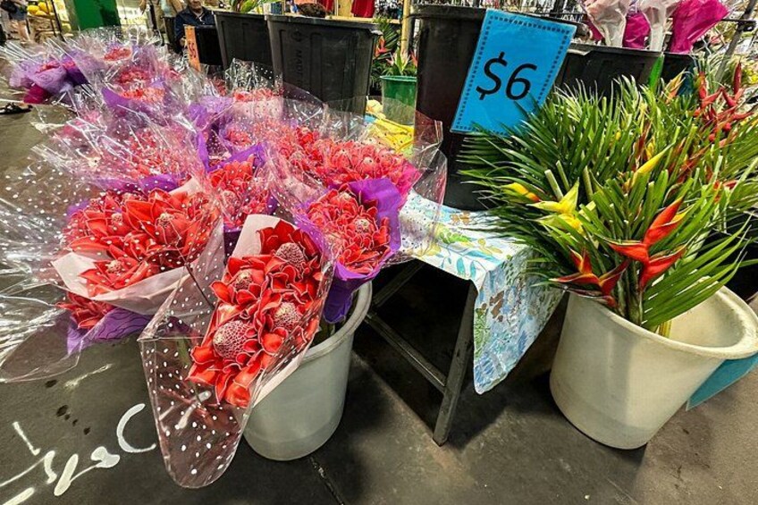 Bouquets of flowers in white buckets with a price tag of $6. 3