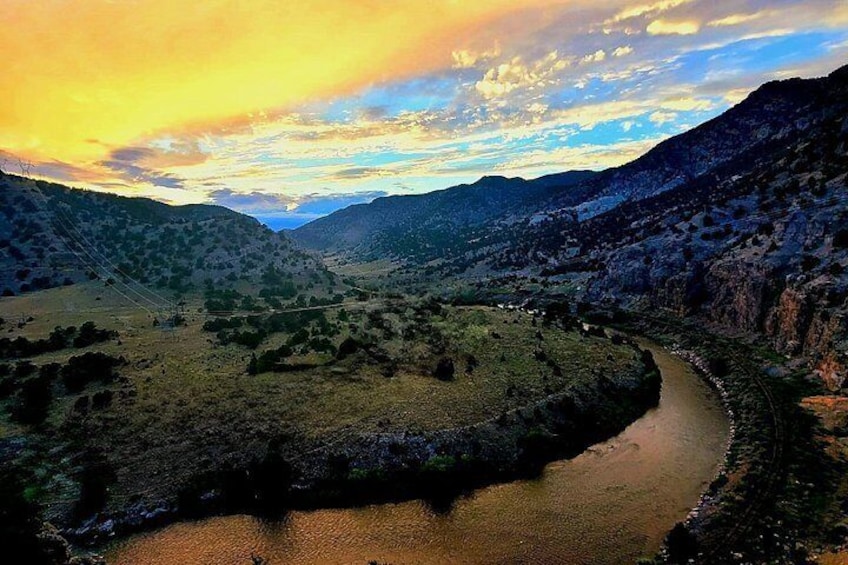 A river winding through a valley with hills on either side. 3