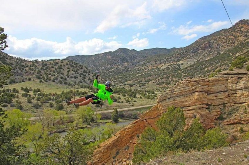 A person skydiving with a parachute over a mountainous landscape. 2