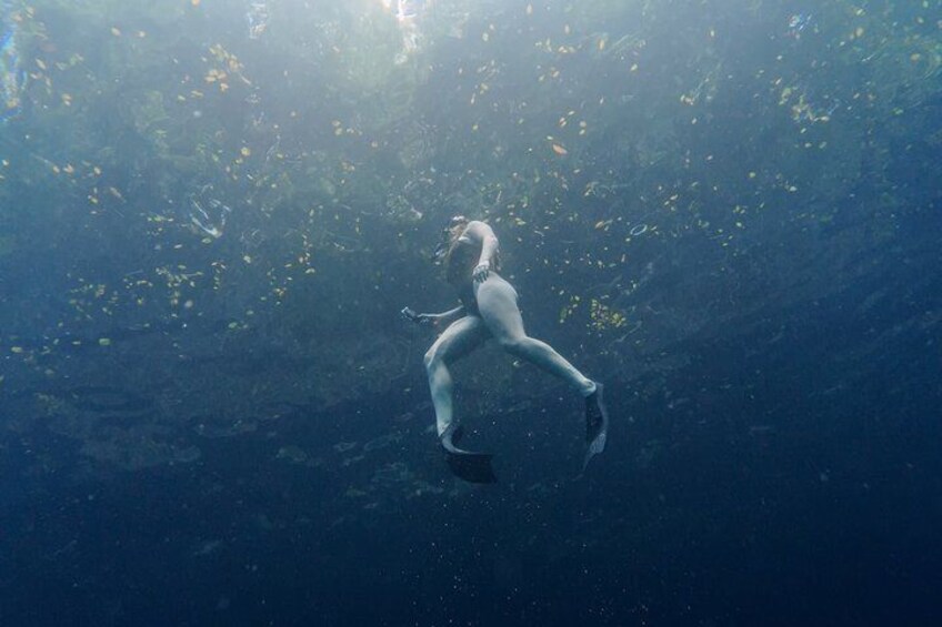 A person swimming underwater. 2