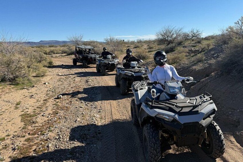 Off-road vehicles on a dirt trail in a desert landscape. 3