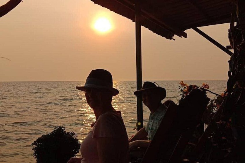 A sunset over the ocean with a person in the foreground. 5