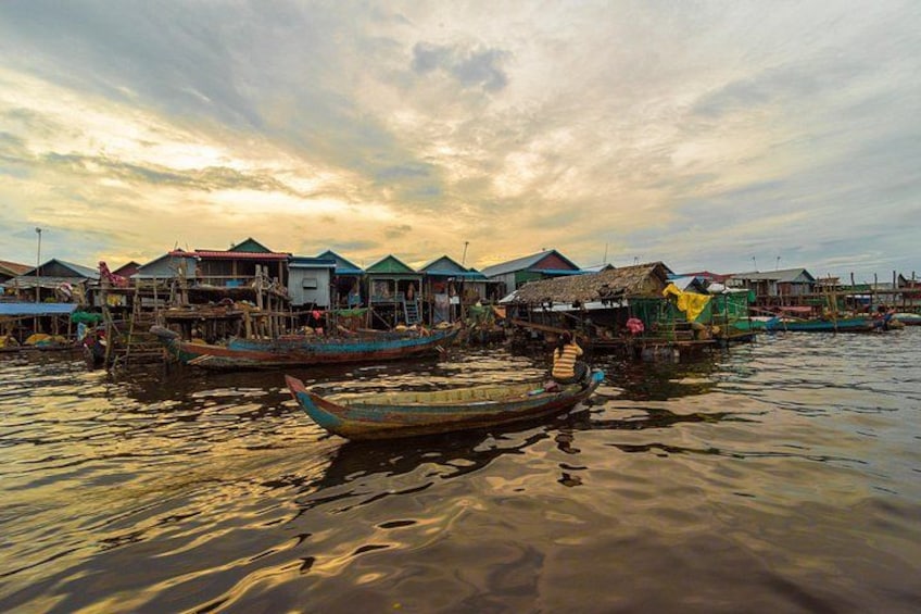 A riverside settlement with traditional houses and boats. 3