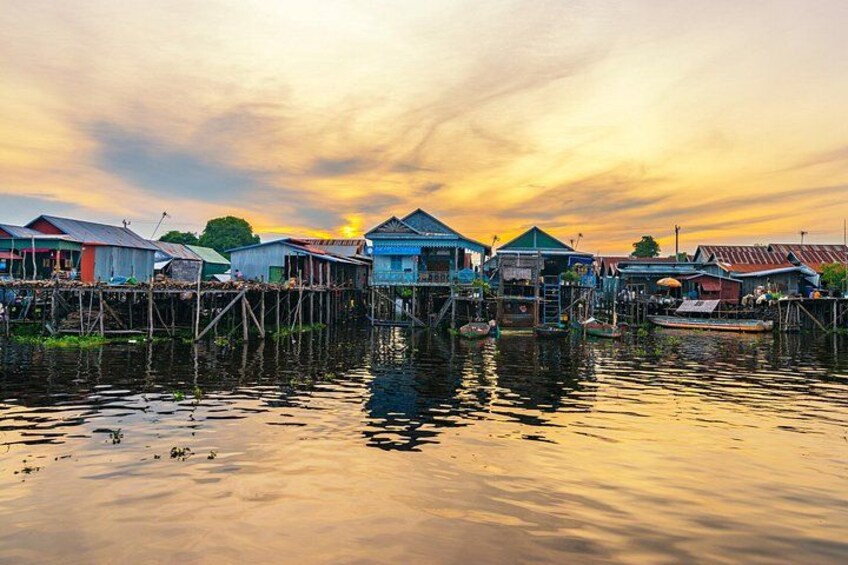 A waterfront village with stilt houses and boats. 2