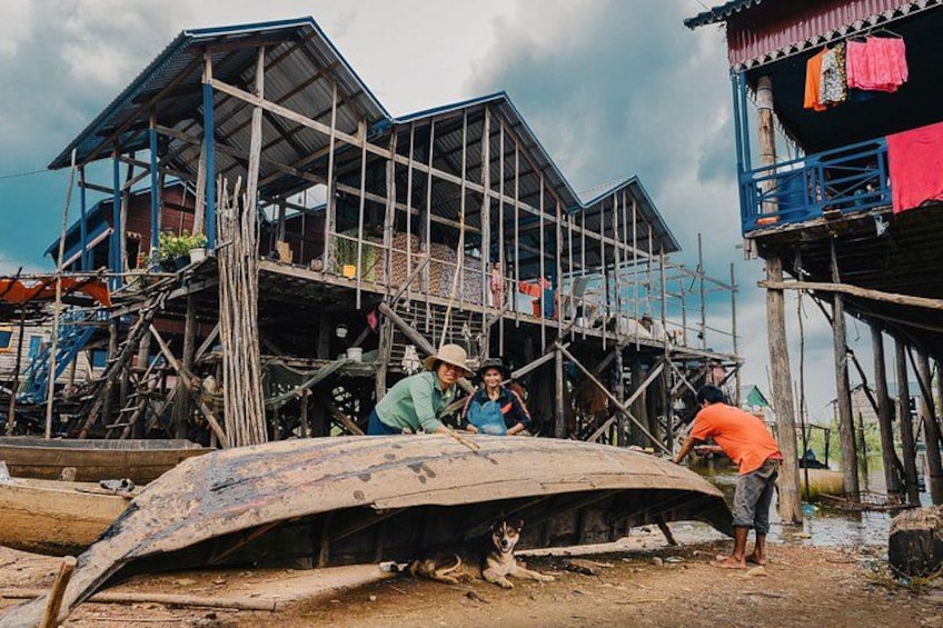A construction site with a partially built structure, a boat, and a dog. 2