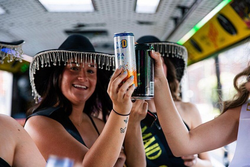 People holding cans, wearing hats with fringes, and a vehicle interior with a ceiling. 3