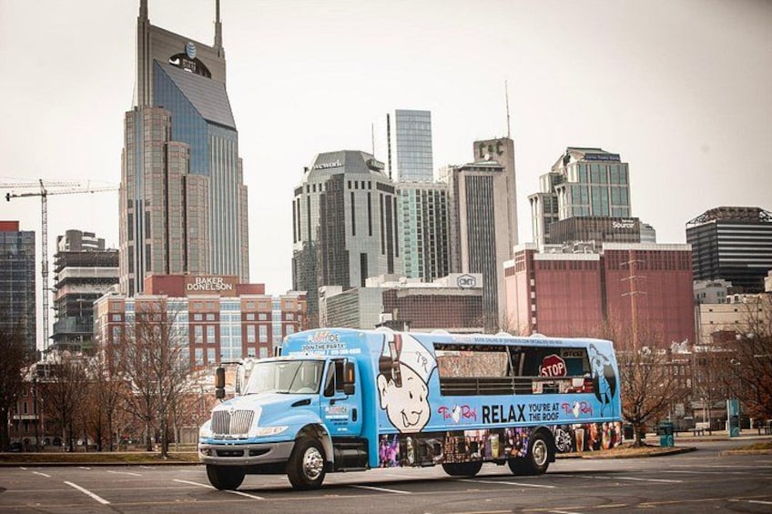 A blue tour bus with a 'Relax' advertisement parked on a city street. 5