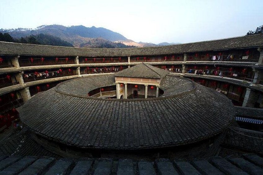 A traditional circular building with multiple balconies and a central open area. 4