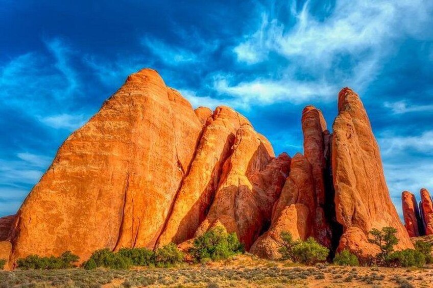 A desert landscape with prominent red rock formations under a clear blue sky. 2