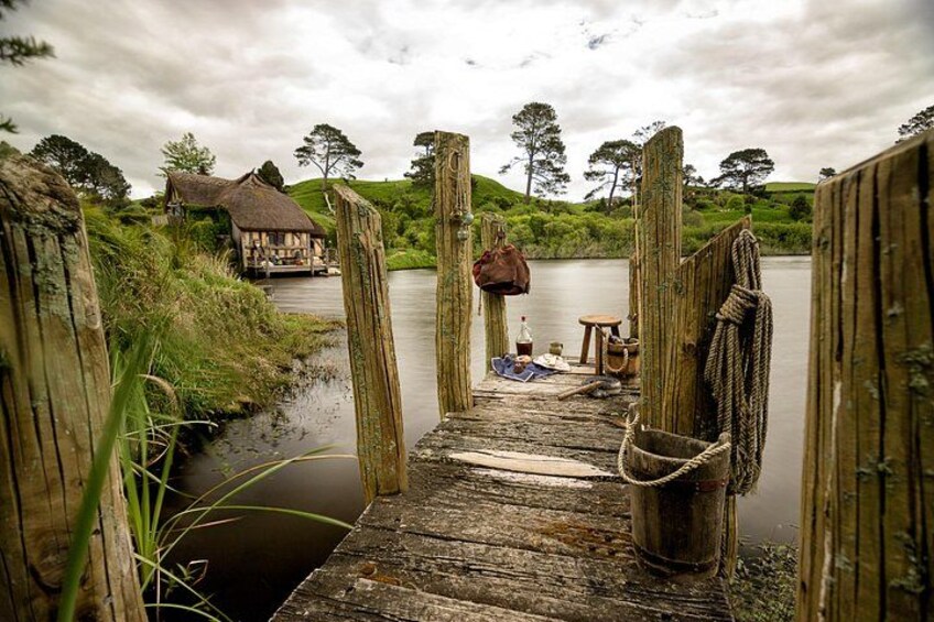 A wooden dock leading to a house by a lake. 3