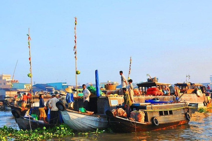 A busy river with boats docked and people engaged in various activities. 4