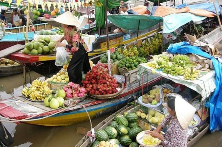A floating market with boats loaded with fruits and vegetables. 5