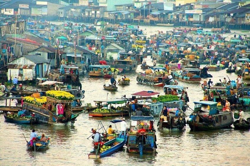 A bustling waterway with numerous boats, some carrying goods, and people engaged in various activities. 3