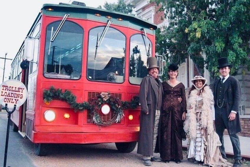 A red trolley with a wreath and a sign that reads 'TROLLEY LOADING ONLY.' 2