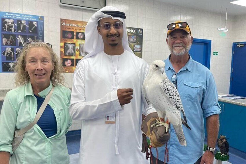 Three people holding a bird in a medical facility. 2