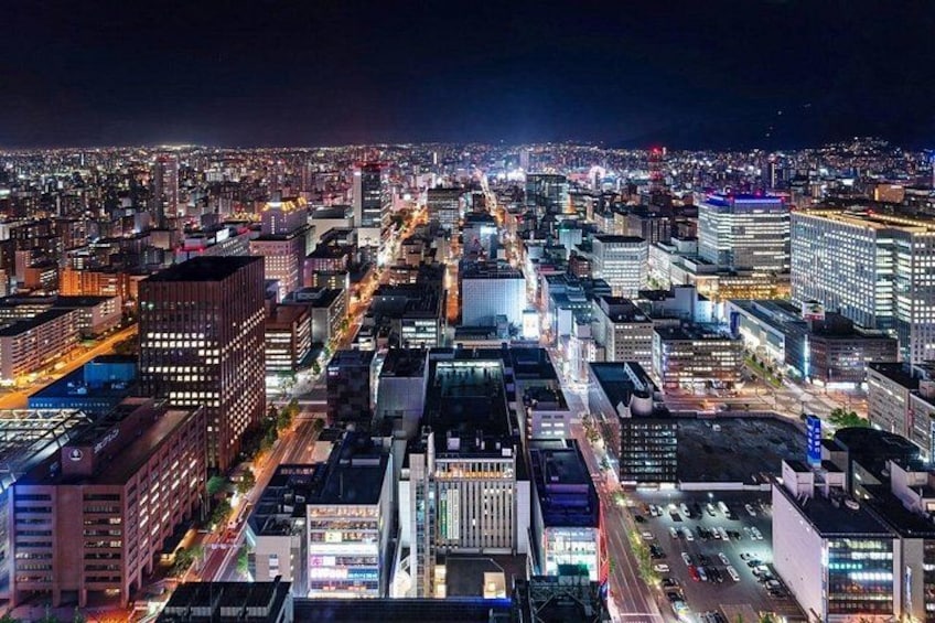 A nighttime cityscape with illuminated buildings and streets. 2
