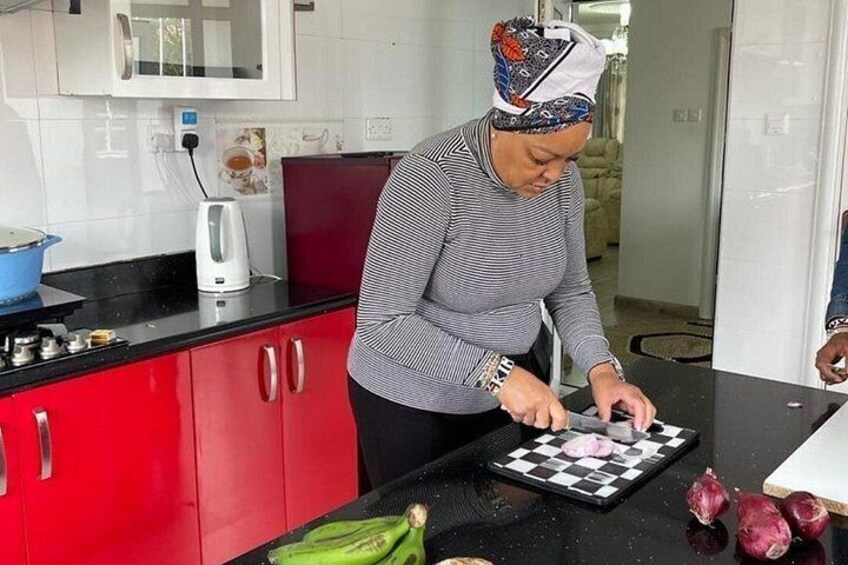 A person chopping vegetables on a kitchen counter. 1