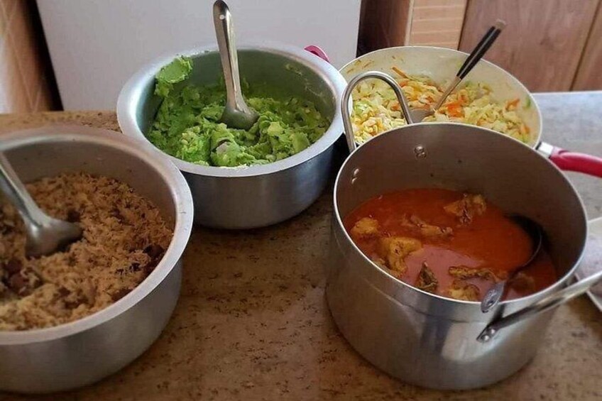 Four metal bowls with different food items on a countertop. 2