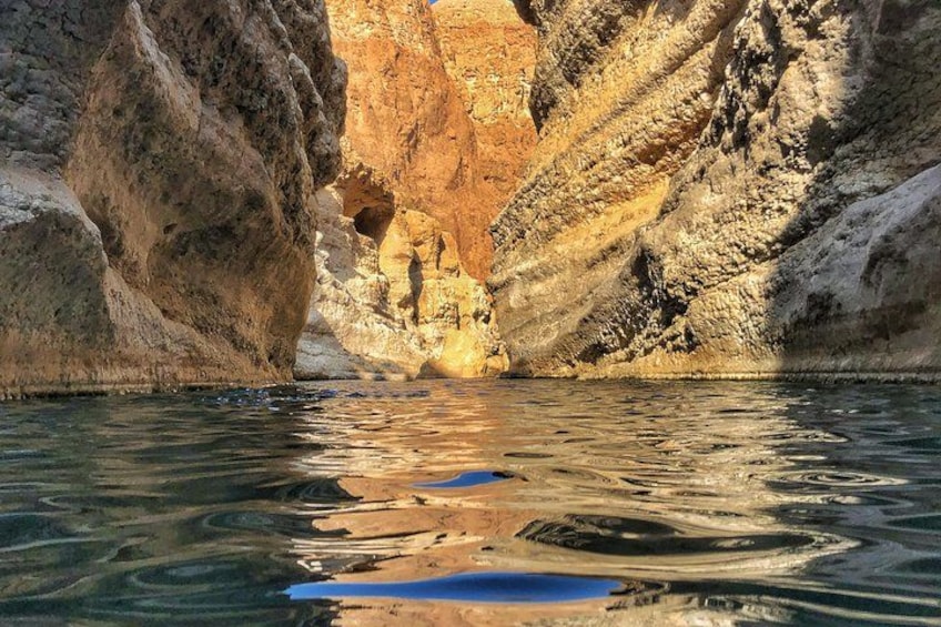 A canyon with water reflecting the rock formations. 2