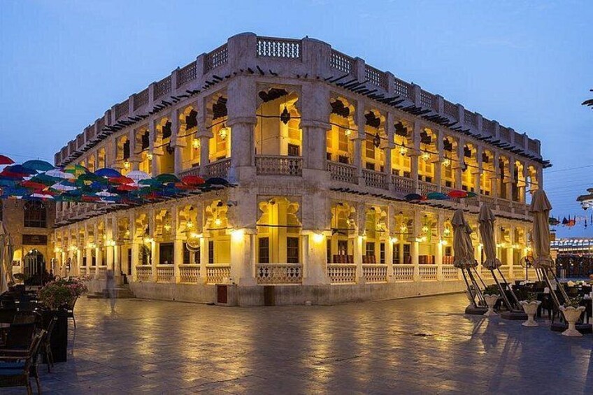 A historic building with multiple balconies and arches, illuminated by warm lighting. 5