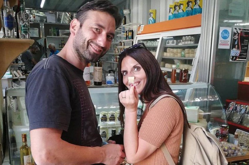 A man and a woman in a store with shelves of products. 2