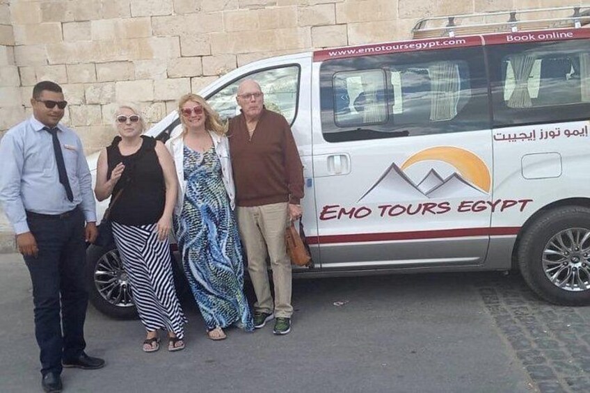 Un gruppo di persone in piedi davanti a un furgone bianco con la scritta 'EMO TOURS EGYPT'. 5