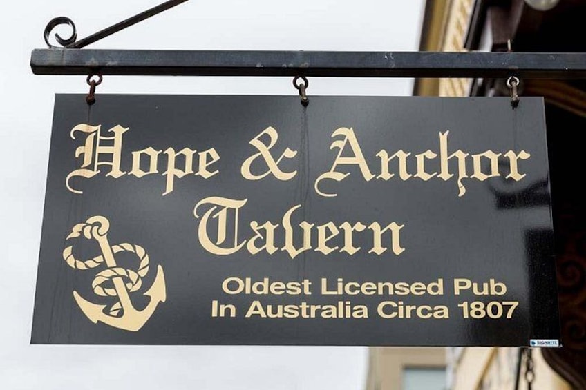 A sign for Hope & Anchor Tavern, an old pub with an anchor symbol, claiming to be the oldest licensed pub in Australia since 1807. 3