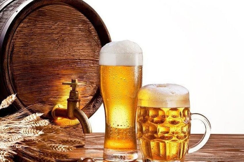 A wooden barrel, a tall beer glass, and a mug with beer. 4