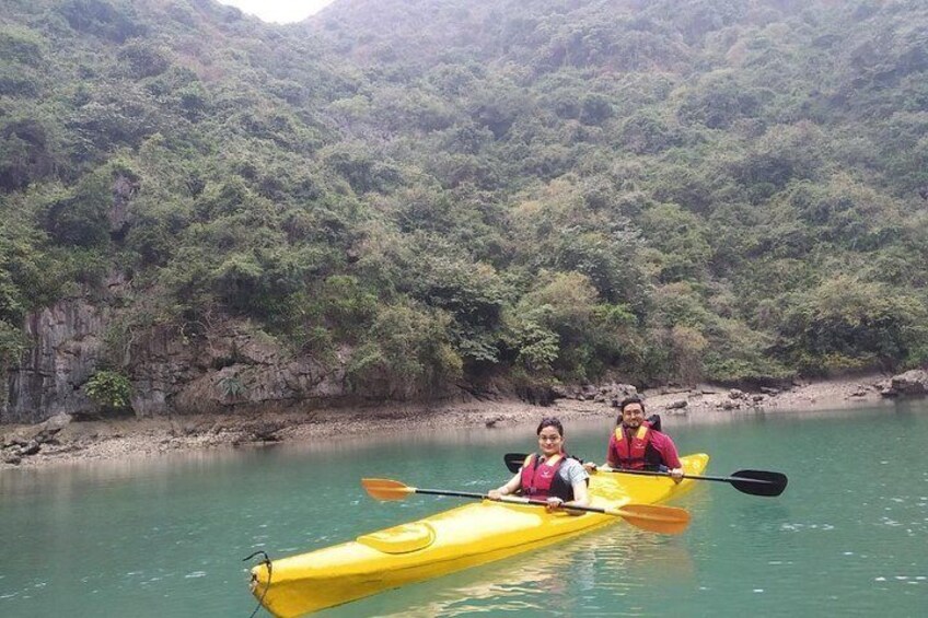 Two people kayaking on a calm river surrounded by lush greenery. 4