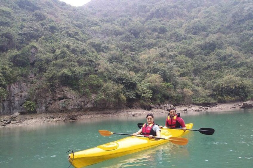 Two people kayaking on a calm river surrounded by lush greenery. 4